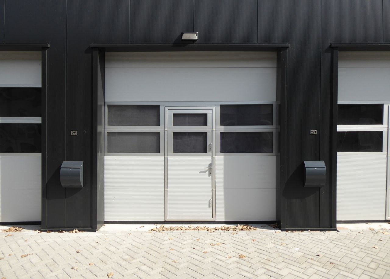 Modern industrial garage door with entrance, suitable for business property.